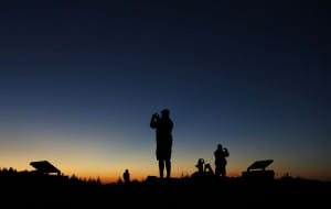 Tourists photograph the sunset at the summit of Cadillac Mountain in Acadia National Park near Bar Harbor, Maine. The 1,528-foot mountain is the highest point on the shoreline of the east coast. (AP Photo/Robert F. Bukaty)