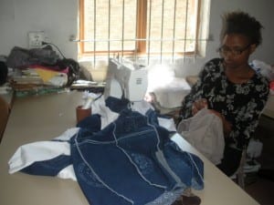 Woman sewing at Imiza Moyethu
