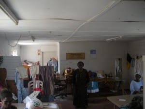 Nobandla stands in the Imiza Moyethu sewing centre