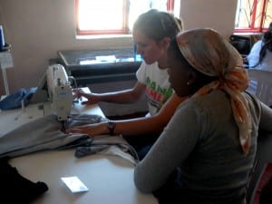 Kayla and Bongeka using the sewing machine