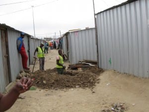 Workers lay pipes in Mtshini Wam to add toilets to nearly every home in Mtshini Wam
