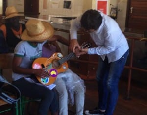Edgar, a co-researcher, taught a Streetscapes participant how to play chords on the guitar.