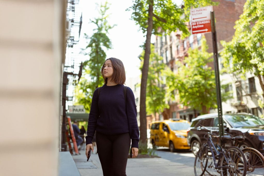 Female Asian student wandering SoHo, NYC, window-shopping