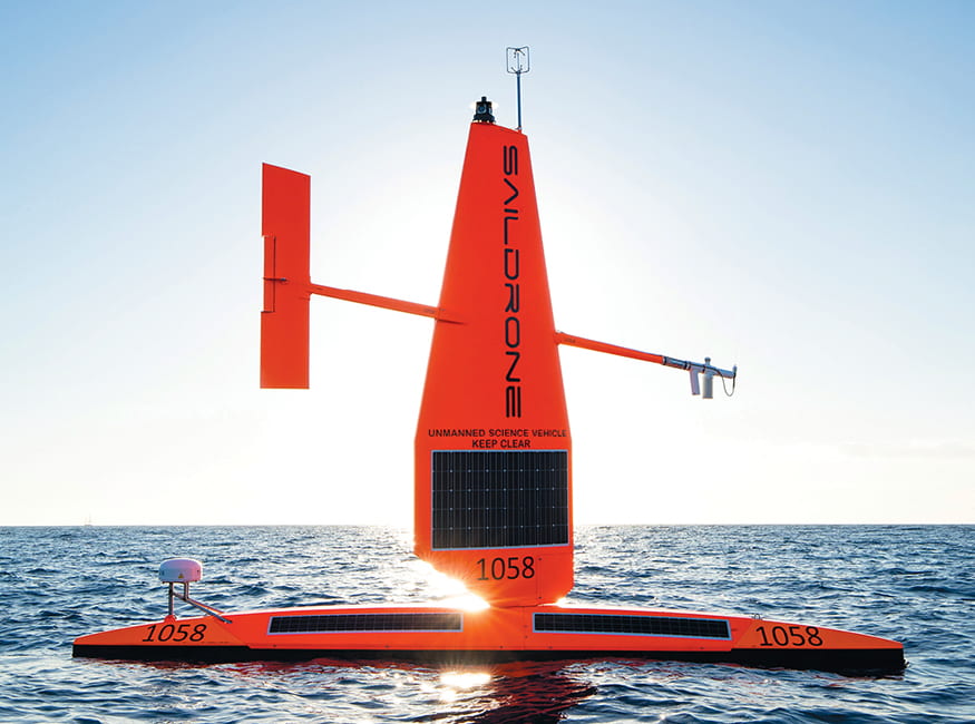Saildrone's Explorer autonomous drone with the sun reflecting off the ocean