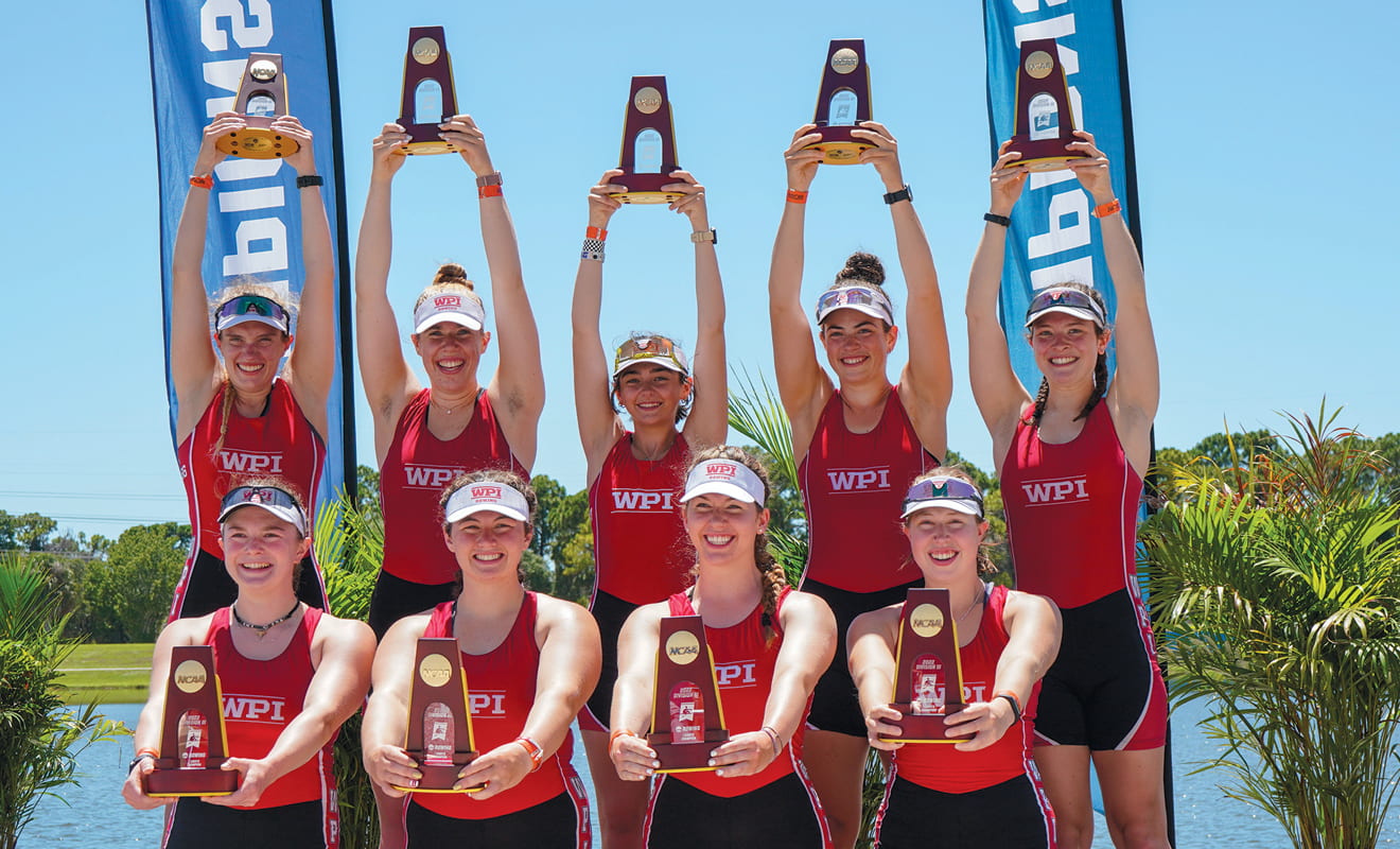 The women's eight team hold their national championship trophies