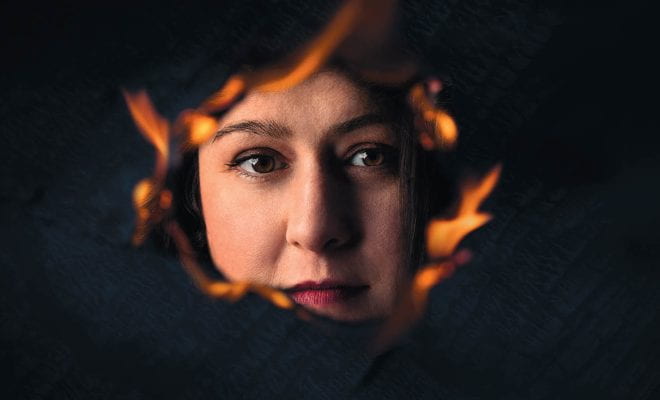 Danielle Antonellis looking through a burning hole