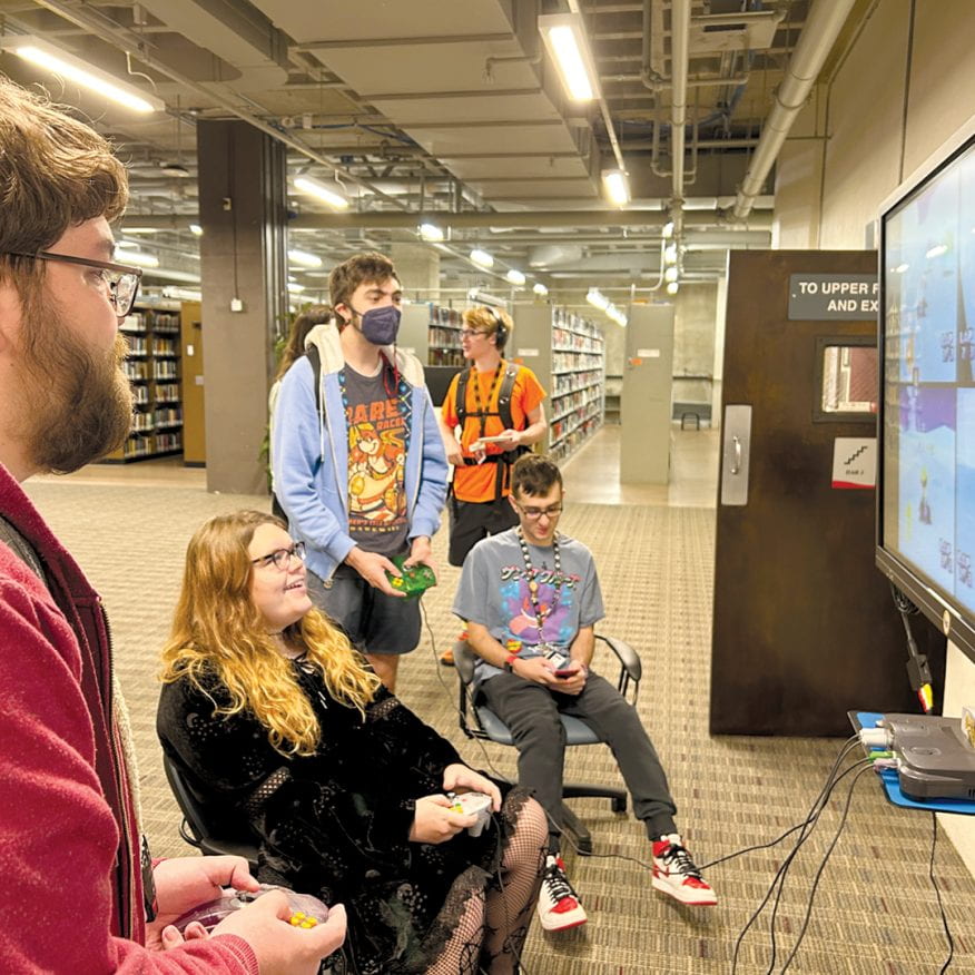 Students and faculty playing vintage video games in the Gordon Library.